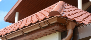 tiled roof against blue sky with clouds idea background with space text ecofriendly traditional roofs home 1 - Top Tejados Lleida
